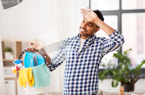 Image of tired man with bucket of cleaning stuff at home