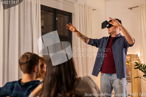 Image of man in vr glasses at home with friends