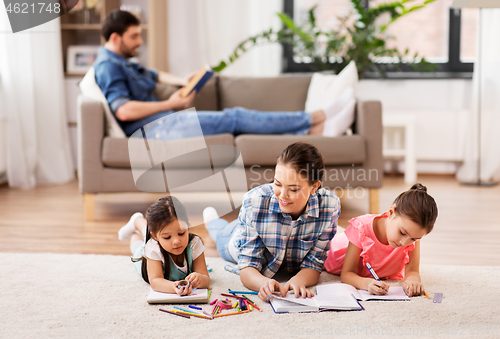 Image of mother with little daughters drawing at home