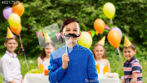 Image of happy boy with black moustaches at birthday party