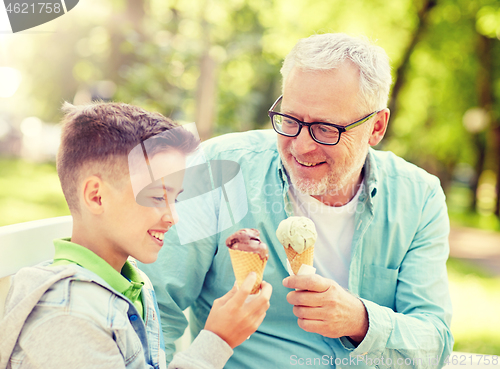 Image of old man and boy eating ice cream at summer park