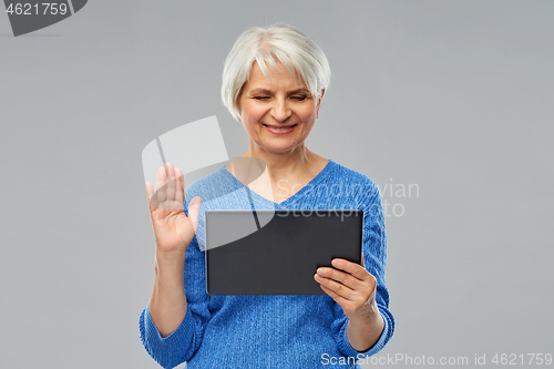 Image of senior woman having video call on tablet computer