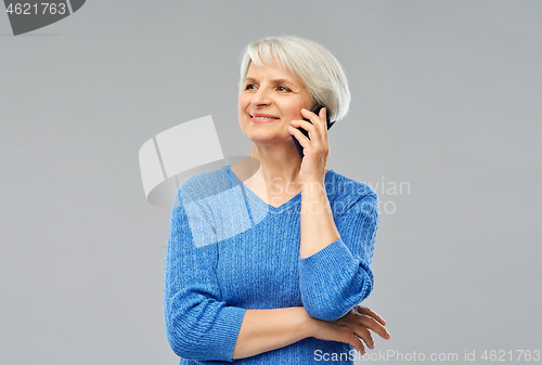 Image of smiling senior woman calling on smartphone