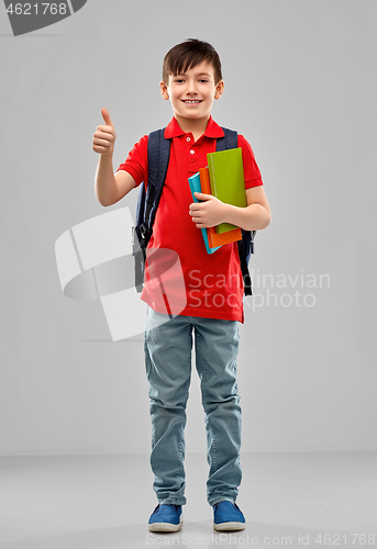 Image of student boy with books and bag showing thumbs up