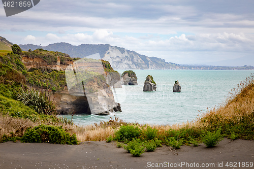 Image of sea shore rocks and mount Taranaki, New Zealand