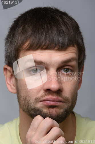 Image of Closeup portrait of a skeptical man of European appearance