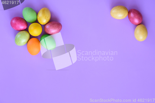 Image of Easter eggs in the shape of a flower on a purple background