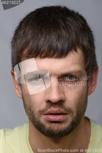 Image of Close-up portrait of a gloomy man of European appearance