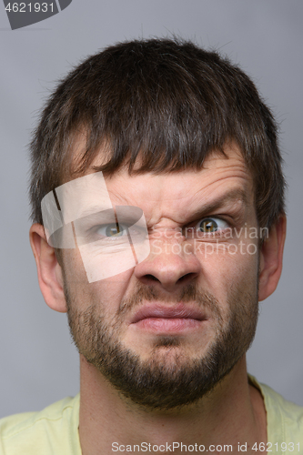 Image of Close-up portrait of a man funny frowning eyebrow of European appearance