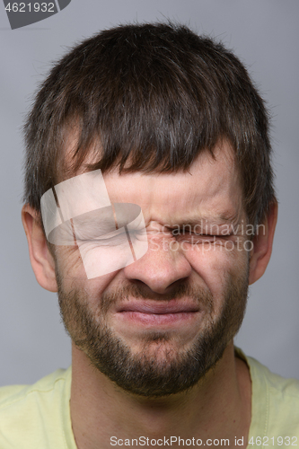 Image of Close-up portrait of a squinted eye of a man of European appearance