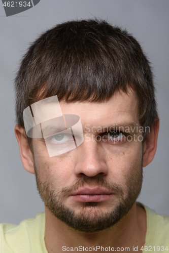 Image of Close-up portrait of a gloomy tired man of European appearance