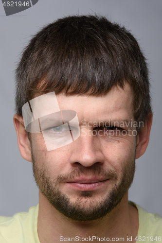 Image of Close-up portrait of a suspicious man of European appearance