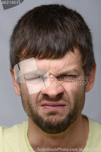 Image of Close-up portrait of a man with an emotion of disgust, European appearance