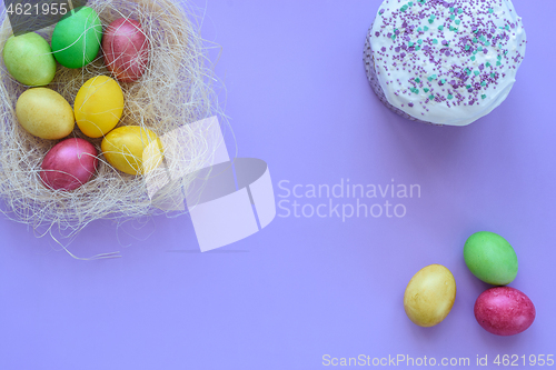 Image of Easter eggs in a makeshift nest on a purple background, next to it is Easter cake and three eggs