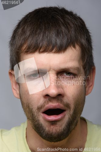 Image of Closeup portrait of a tired yawning man of European appearance