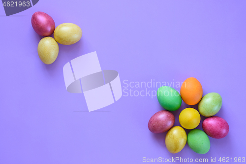 Image of Easter beautiful eggs in the shape of flowers on a purple background