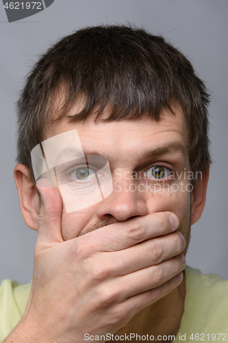 Image of Close-up portrait of a man of European appearance, depicting a fright