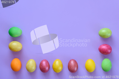 Image of Easter eggs laid out around the perimeter on a purple background