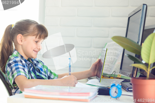 Image of Happy girl watching entertaining online video tutorial