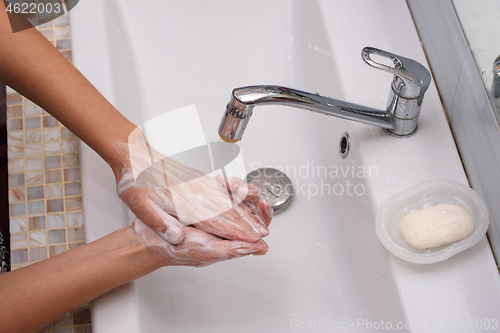 Image of Female hands wash their hands thoroughly with soap