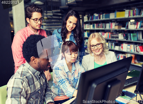 Image of international students with computers at library