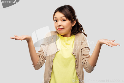 Image of clueless asian woman shrugging