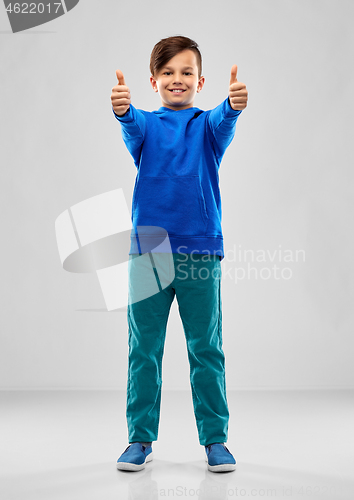 Image of smiling boy in blue hoodie showing thumbs up