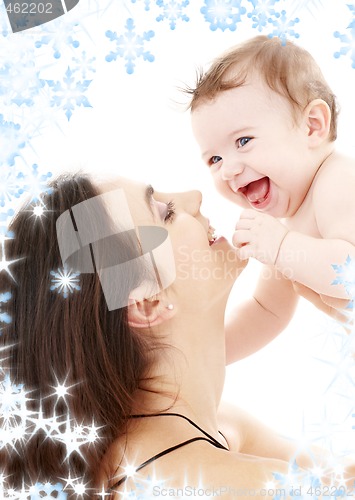 Image of laughing blue-eyed baby playing with mom