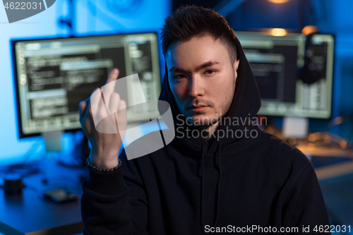 Image of hacker with computers showing middle finger