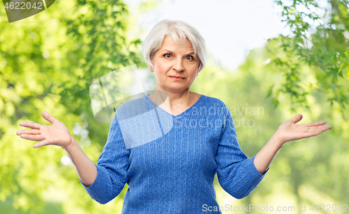 Image of senior woman having no idea and shrugging