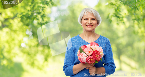 Image of happy smiling senior woman with flowers