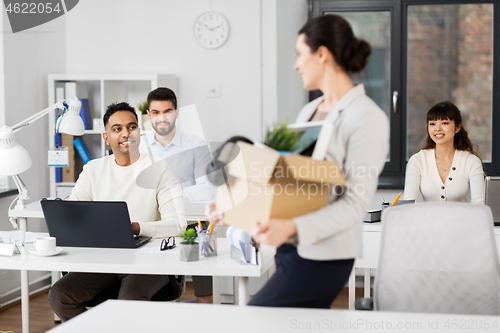 Image of new female office worker with personal stuff