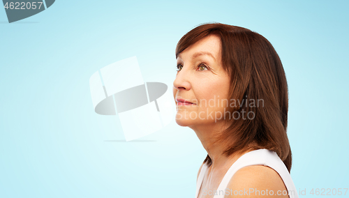 Image of portrait of senior woman over blue background