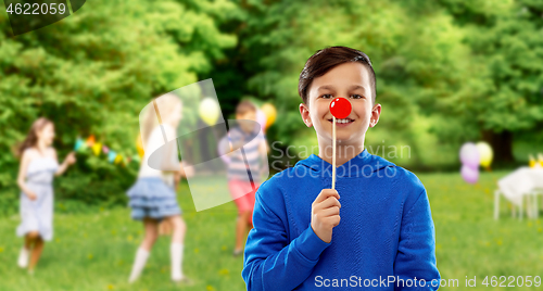 Image of happy boy with red clown nose at birthday party