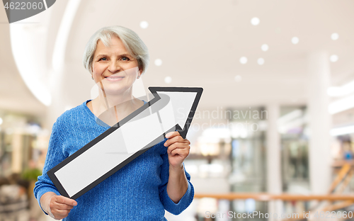 Image of smiling senior woman with big rightwards arrow