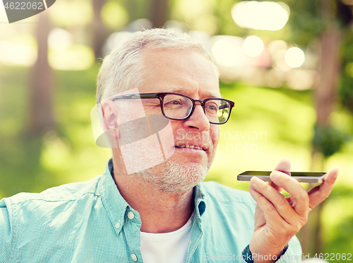 Image of old man using voice command recorder on smartphone