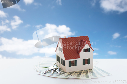 Image of close up of home or house model and money