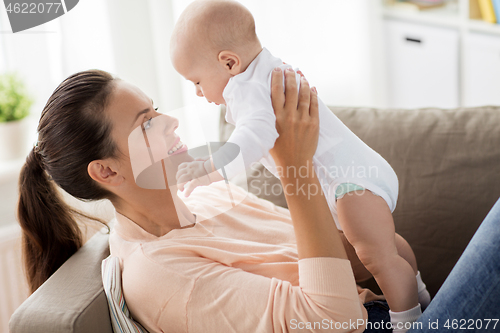 Image of happy mother with little baby boy at home