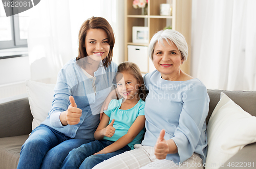 Image of mother, daughter and grandmother showing thumbs up