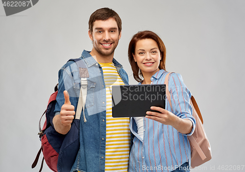 Image of happy couple of tourists with tablet computer