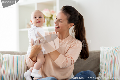 Image of happy mother with little baby boy at home