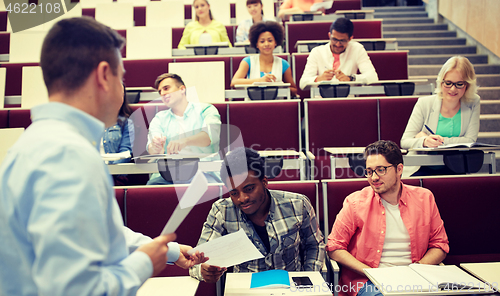 Image of teacher giving tests to students at lecture