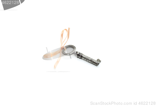 Image of Vintage silver key with pink bow on white