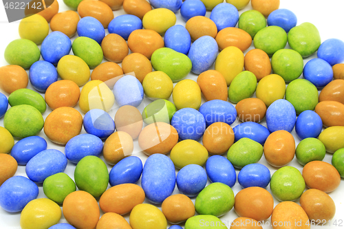 Image of Multicolored glazed chocolate candies on a white