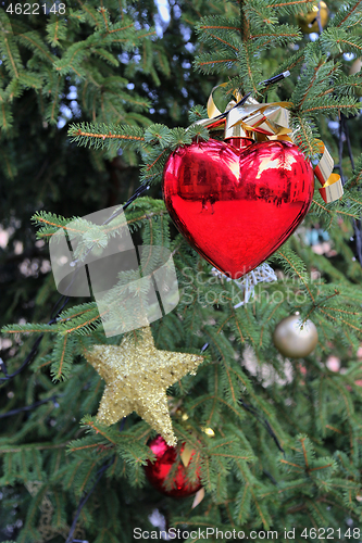 Image of Beautiful decoration with heart toy on the branches of the Chris