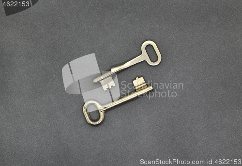 Image of Two keys on gray paper background, close up