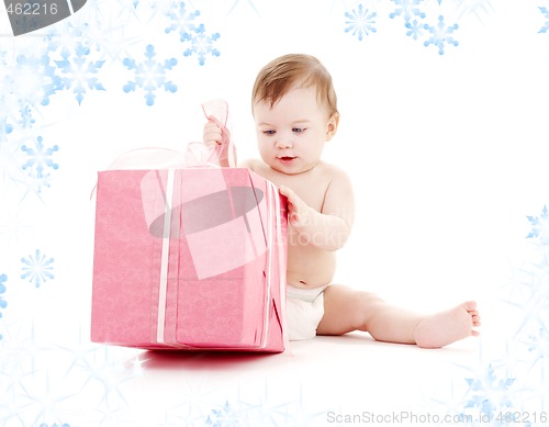 Image of baby boy in diaper with big gift box