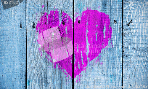 Image of Abstract heart painted on a wooden wall 