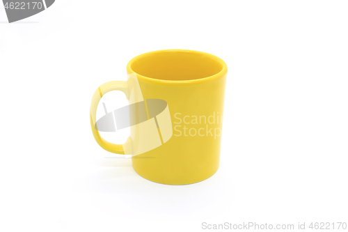 Image of Bright yellow ceramic cup on white background