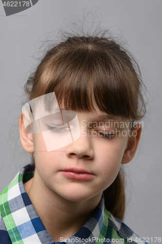 Image of Portrait of a ten-year-old girl with closed eyes, European appearance, close-up